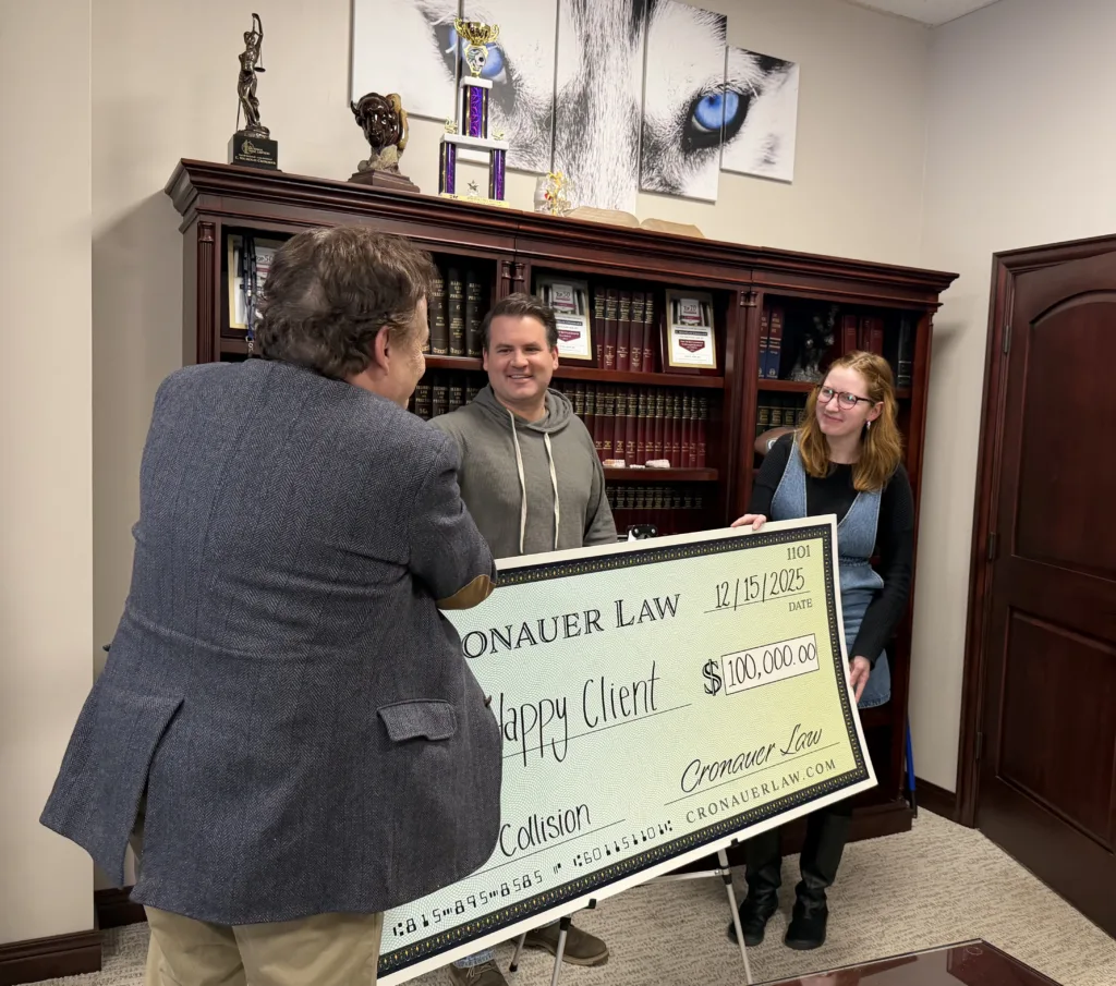 Cronauer Law team with client after securing a $100,000 settlement from a car crash
